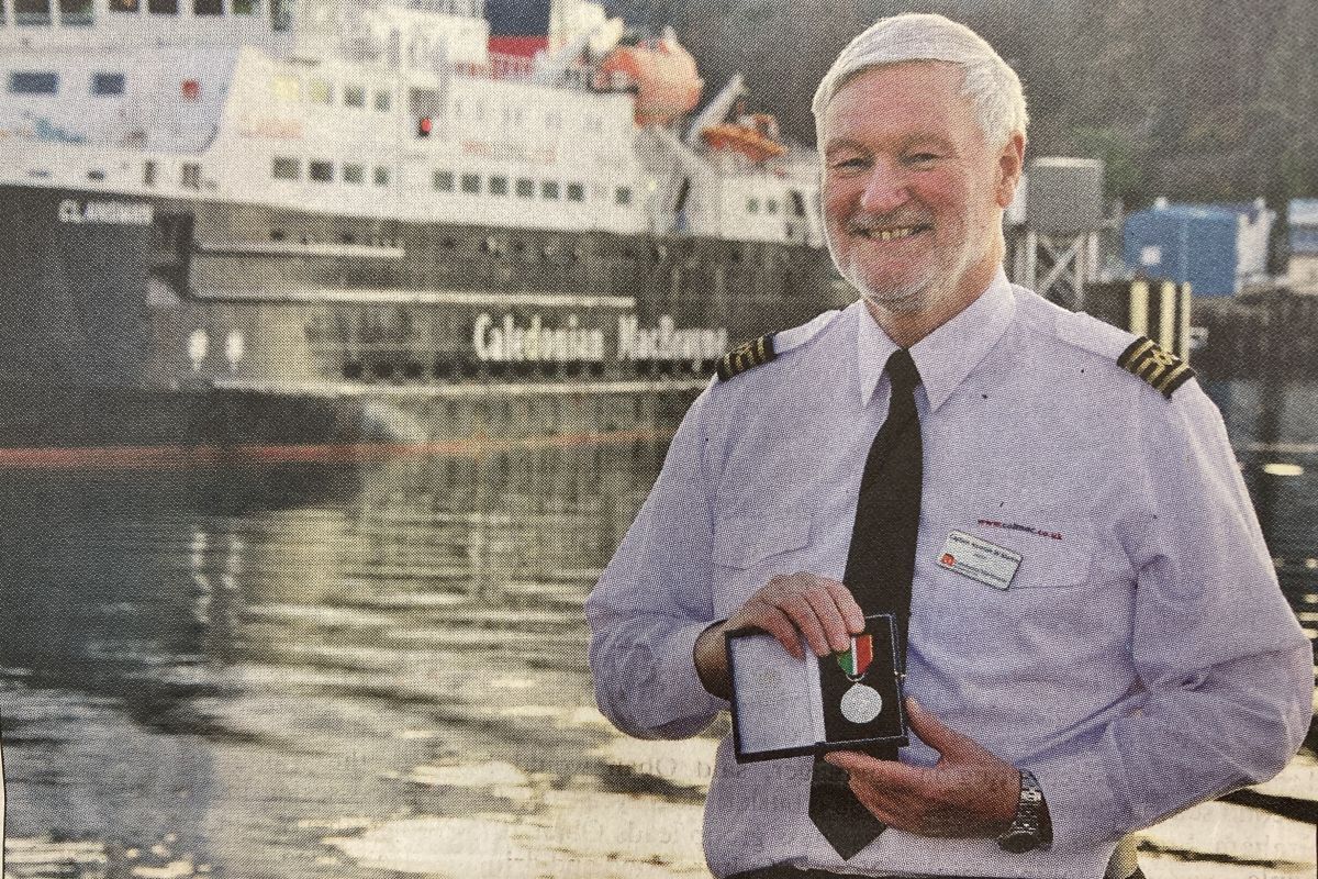 2014: CalMac ship’s captain Norman Martin with the prestigious Merchant Navy Medal he received from Lord West at a ceremony in London. 