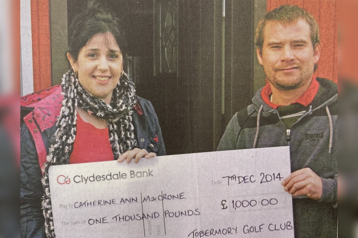 2014:  Tom Nun presents the Christmas cheque to Catherine Ann MacCrone.