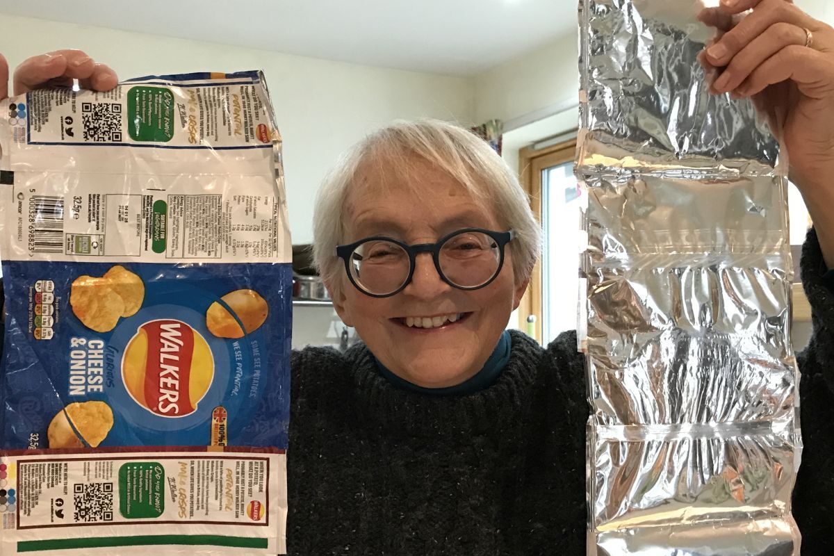 Sue Fenton with the strips she makes by ironing empty crisp packets together ready to be turned into foil blankets by a charity in Hastings.