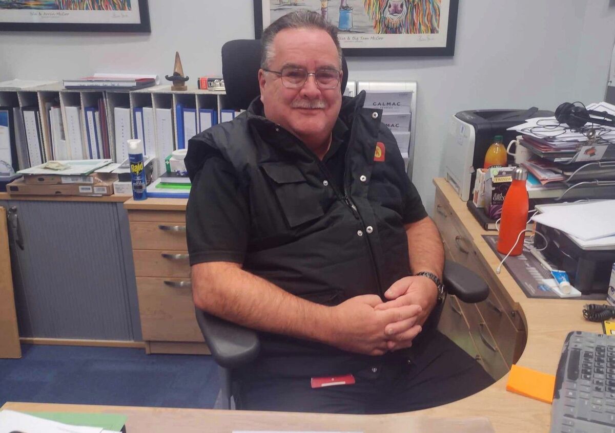 Colin McCort at his desk at Brodick ferry terminal. Photograph: CalMac. 