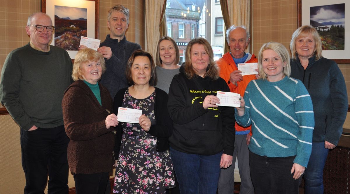 Representatives from four charities received their cheques sharing £800 from a festive concert organised by Oban Gaelic Choir and donations. 