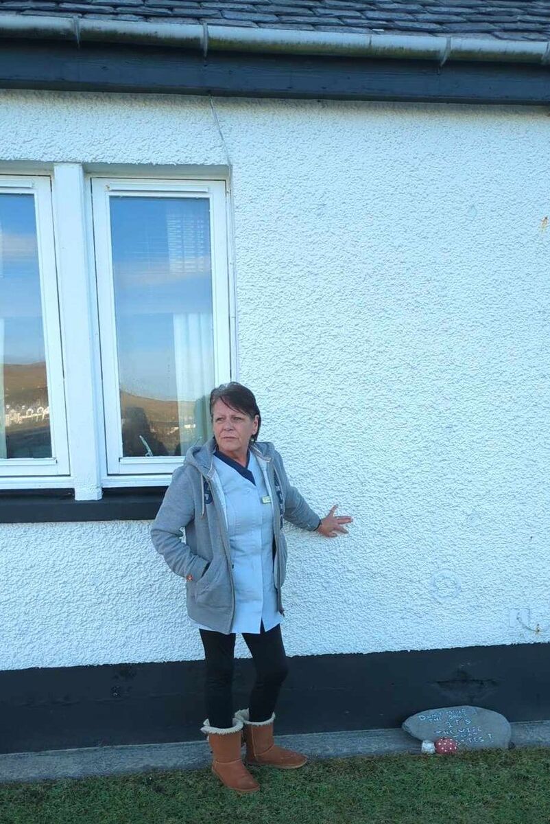 Heartbroken flood victim Joanne Ferguson outside her bungalow in Fredrick Crescent, Port Ellen