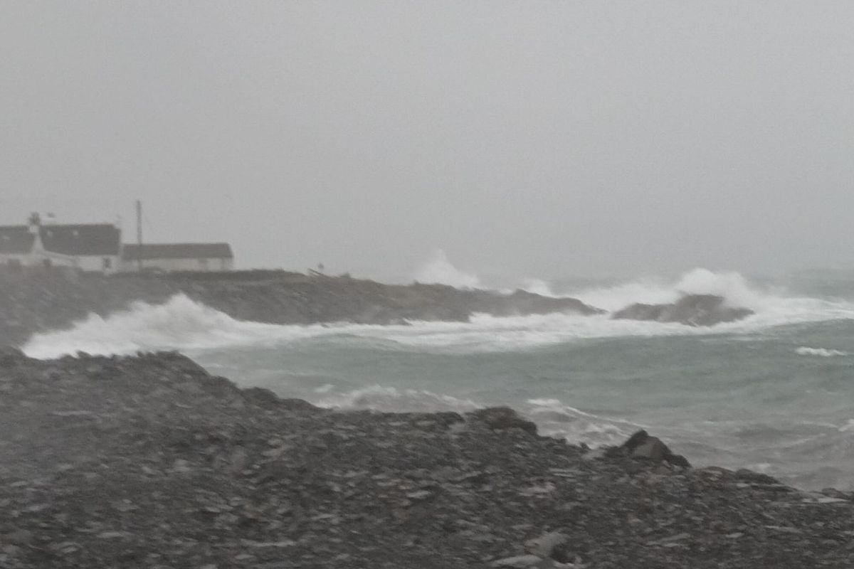 Hazy view of Cullipool through the storm spray as waves lashed the village's sea defences that stayed strong.