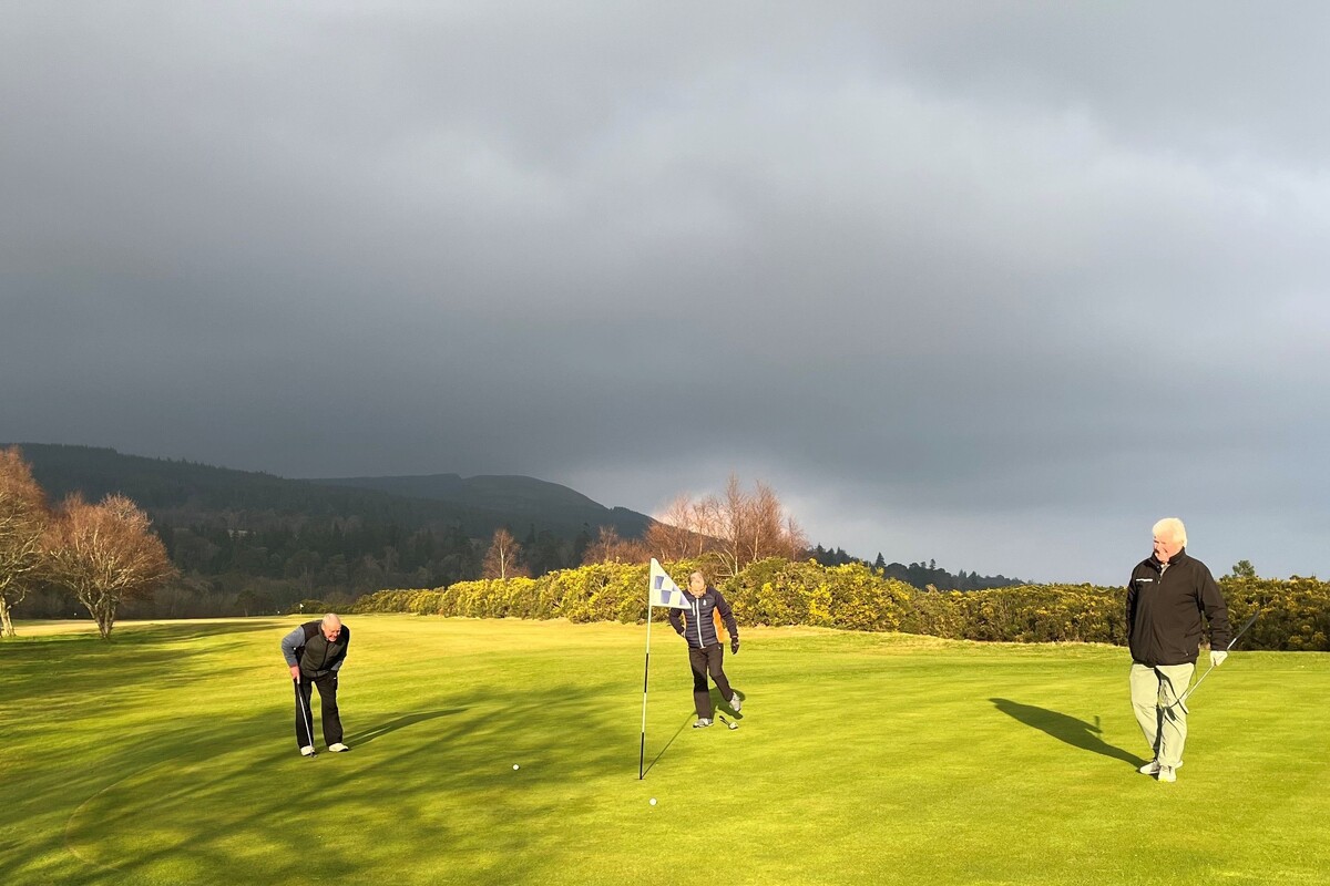 Brodick Golf Club’s Terry Raeside, John May and Dougie Robertson line up their putts at the 13th hole during this week's Winter Cup. Photograph: BGC.