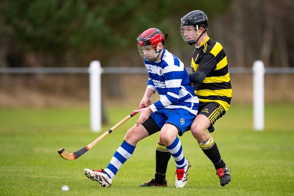 Col-Glen's 2025 captain Andrew Tyre tries to get round Newtonmore's new signing from Oban Matthew Sloss. Photograph: Neil G Paterosn