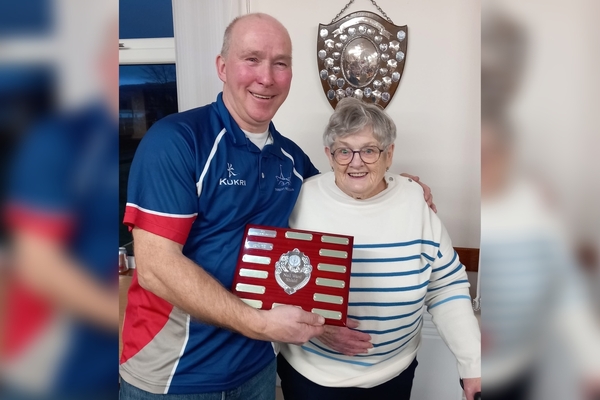 President of Tarbert Bowling Club Duncan MacGregor receives the Neil Ward Shield from Nannie Ward. Photograph: Lochgilphead Bowling Club