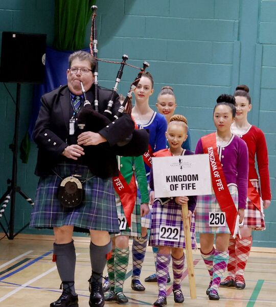 Piper Donald MacPhee leads in the reigning Scottish Area Champions to the Scottish Area Finals at the start of the Highland Dancing competition on Saturday morning. Photograph: Kevin McGlynn