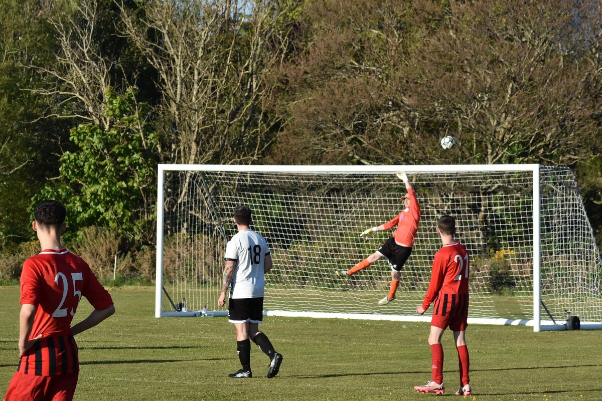 The Lamlash keeper fends off a Shiskine attack on goal. The Lamlash keeper fends off a Shiskine attack on goal.