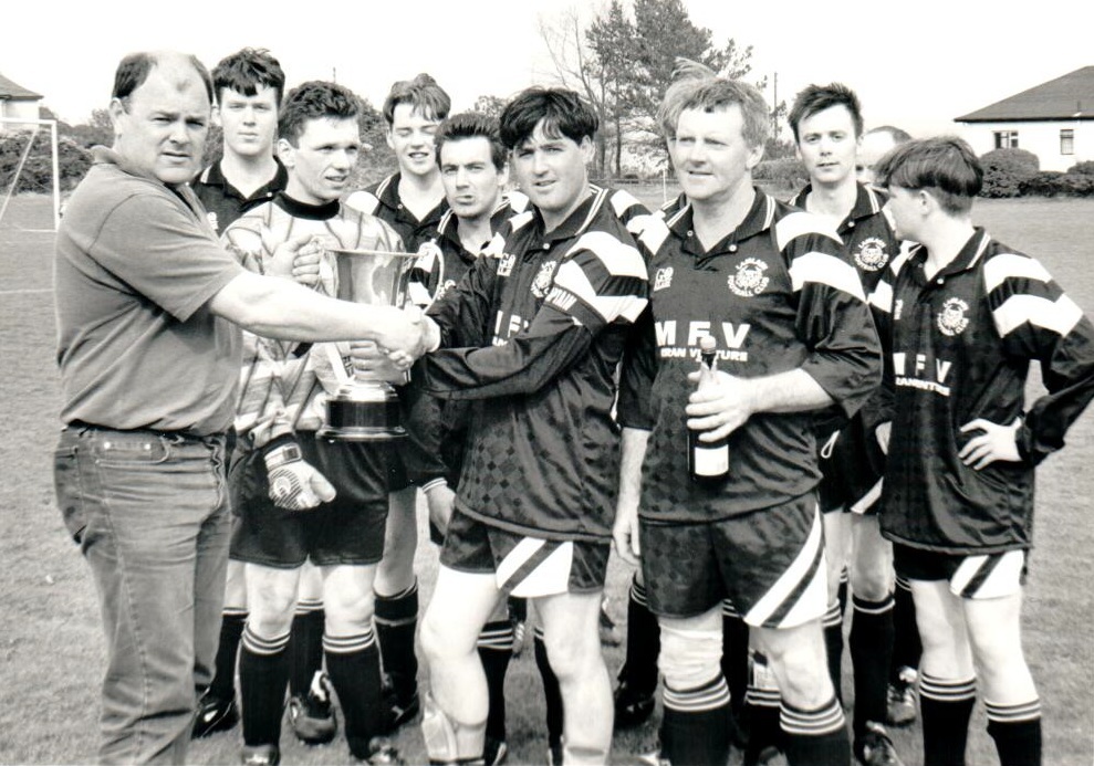 Iain Small presents the Arran Haulage Cup to Dougie Macfarlane after the Lamlash victory. Iain Small presents the Arran Haulage Cup to Dougie Macfarlane after the Lamlash victory.