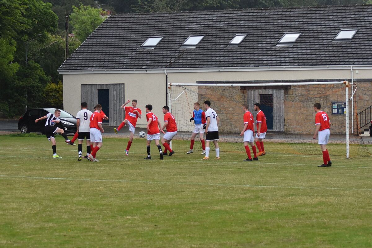 Kellen Craig blasts the ball through a wall of Shiskine players to secure the first goal of the match. Kellen Craig blasts the ball through a wall of Shiskine players to secure the first goal of the match.