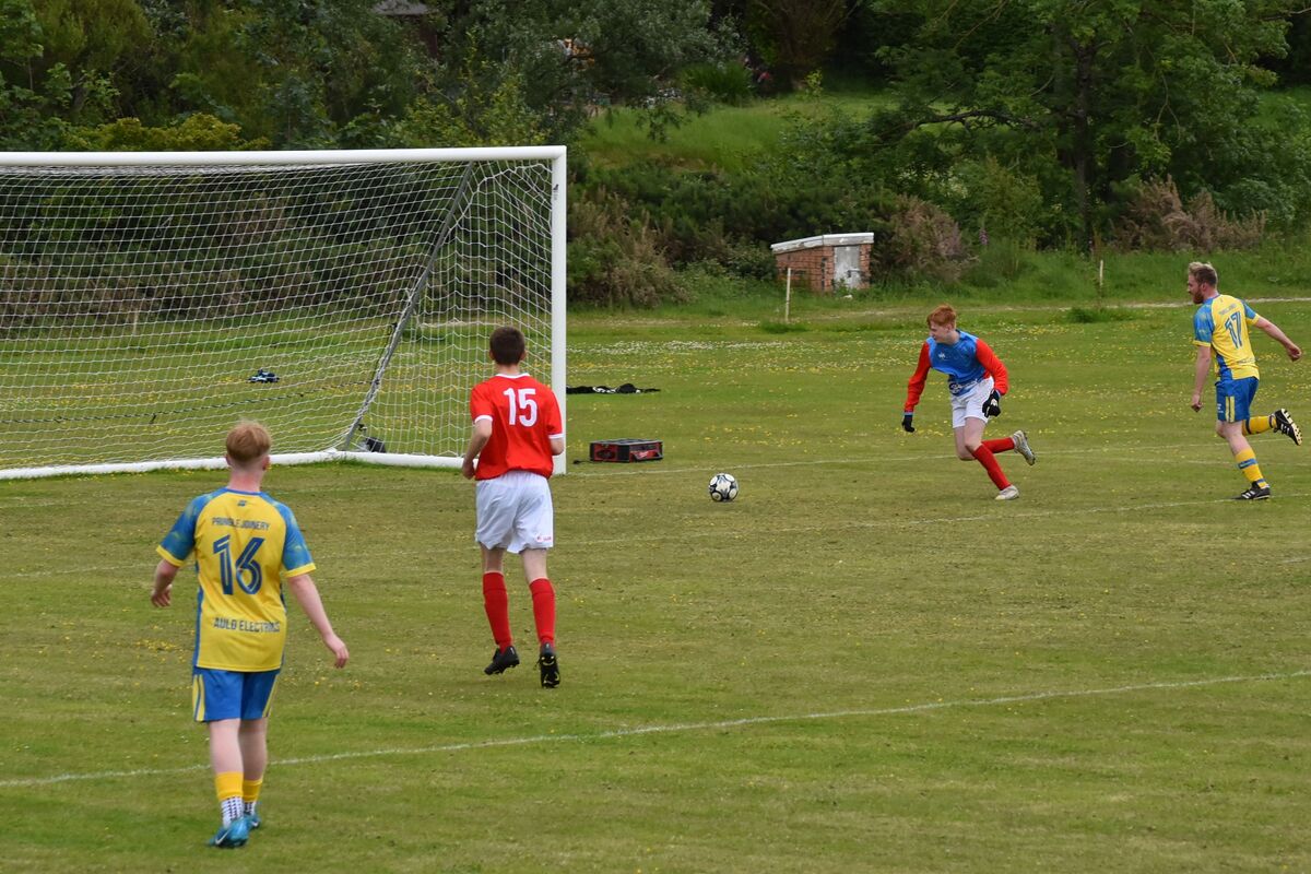 Alastair Eccles-Wood watches as the Shiskine keeper unsuccessfully tries to intercept his goal. Alastair Eccles-Wood watches as the Shiskine keeper unsuccessfully tries to intercept his goal.
