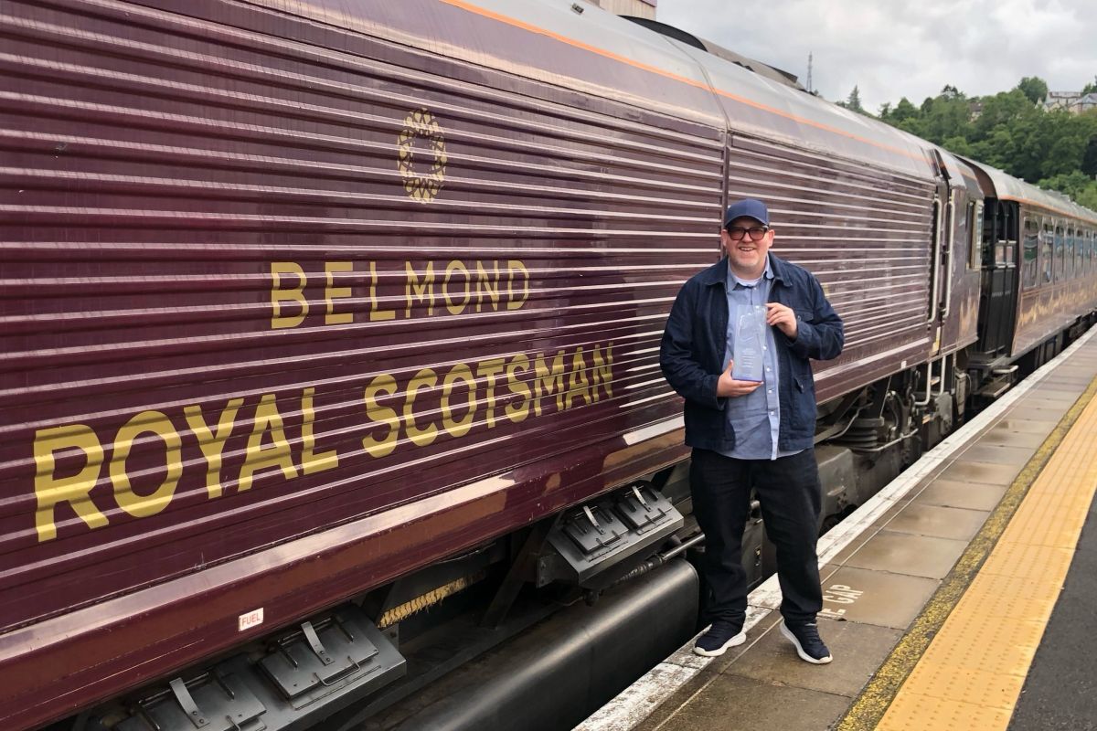 James Gray with his RTS award next to the Royal Scotsman on track for another accolade.