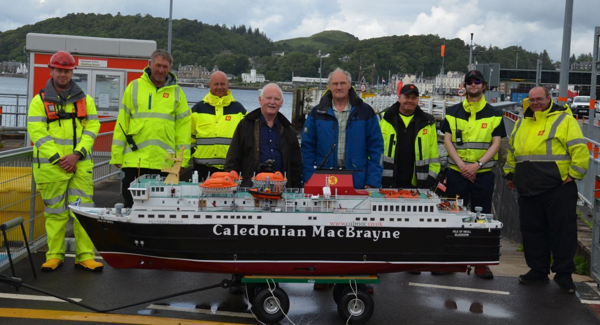 John McNulty and Alan Sinclair with the refurbished MV isle of Mull model and with CalMac staff. Photograph: Alan Sinclair John McNulty and Alan Sinclair with the refurbished MV isle of Mull model and with CalMac staff. Photograph: Alan Sinclair