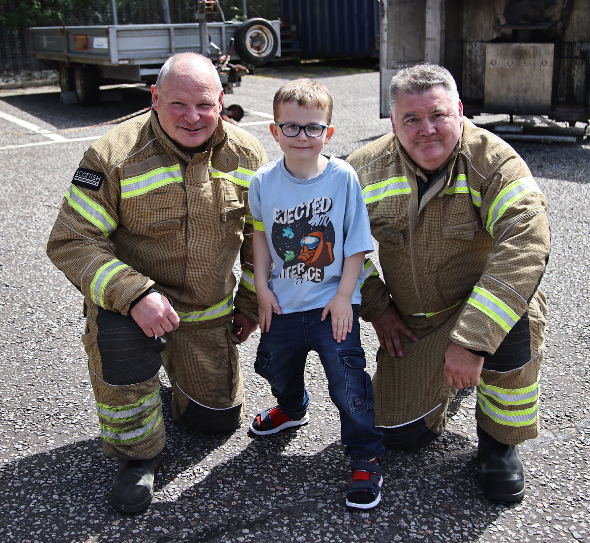 Gerry Ralston and Colin Fleming MacLean with a budding firefighter of the future. Photograph: Kevin McGlynn