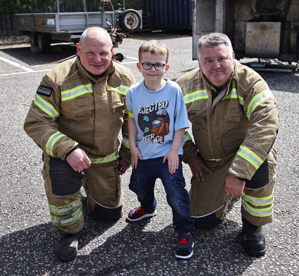 Gerry Ralston and Colin Fleming MacLean with a budding firefighter of the future. Photograph: Kevin McGlynn