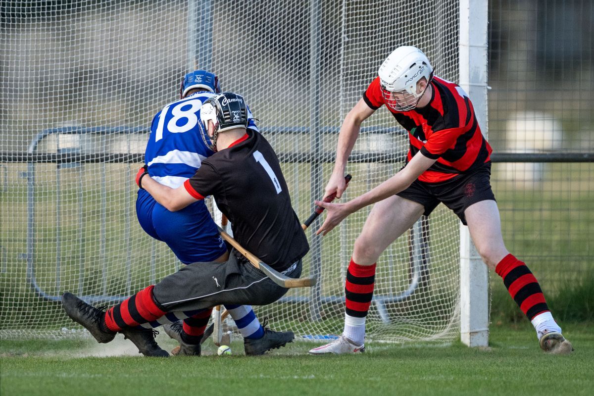 Oban's keeper Cameron Sutherland and defender Logan Black stop Struan Ross scoring for Newtonmore. Photo - Neil Paterson