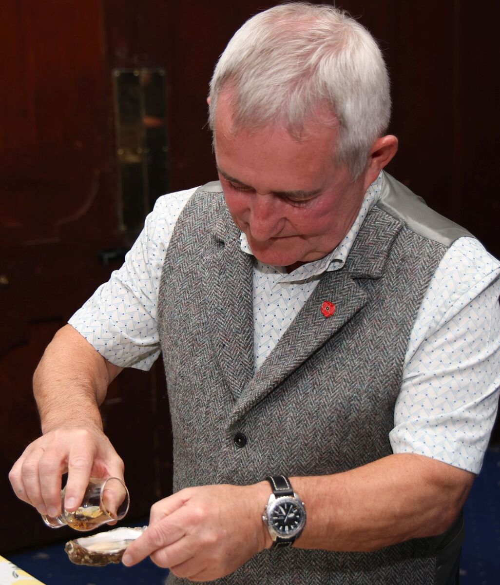 Frank McKenna prepares an oyster slanjz - two drops of malt on the oyster and then swallow. Photograph: Kevin McGlynn