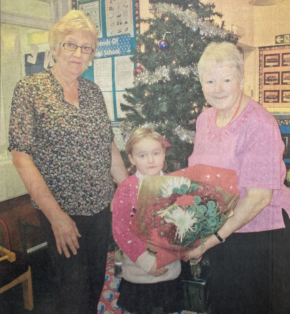 2016: Primary one teacher Margaret Stewart, left, with pupil Brooke Falconer, presenting Mary MacColl with flowers on her last day at Caol primary.