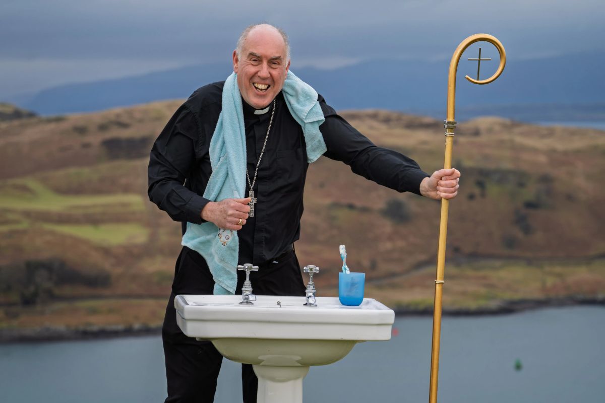 By hook or by crook, Bishop Brian was determined to top the hill with the bathroom sink to highlight water poverty. Photograph: James Cave By hook or by crook, Bishop Brian was determined to top the hill with the bathroom sink to highlight water poverty. Photograph: James Cave