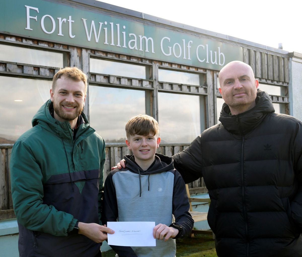 Fifteen year old Harry Stewart and his dad, John were presented with a &pound;500 cheque to help furtrher his golfing career by Fraser Gray (left) Youth Convener of Fort William Golf Club. Photograph: Iain Ferguson, alba.photos.