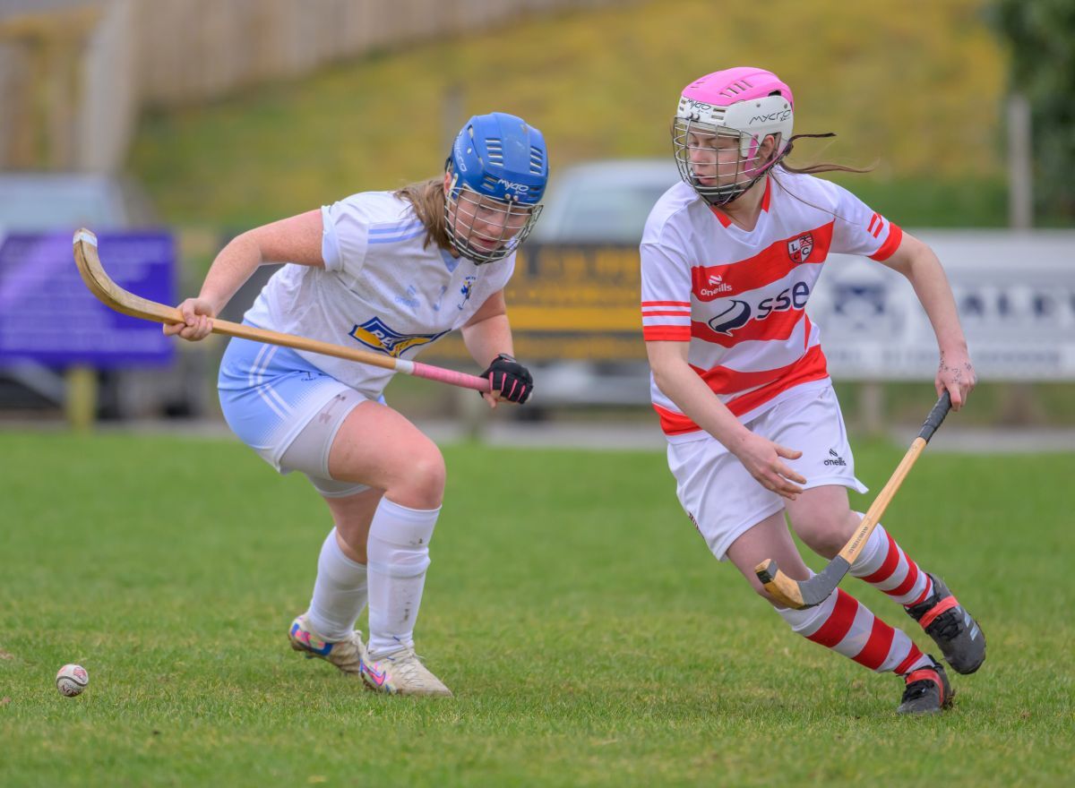 Lochaber's Leah Maxtone slips the ball past Christina MacDonald (Skye). Photograph: Phil Hughes.