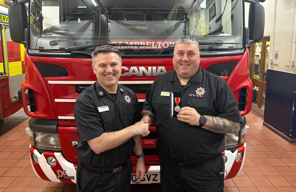 Area Commander Joy McKay, left, presents firefighter Scott Campbell with his Long Service and Good Conduct Medal in recognition of more than 20 years&rsquo; service at Campbeltown Fire Station.