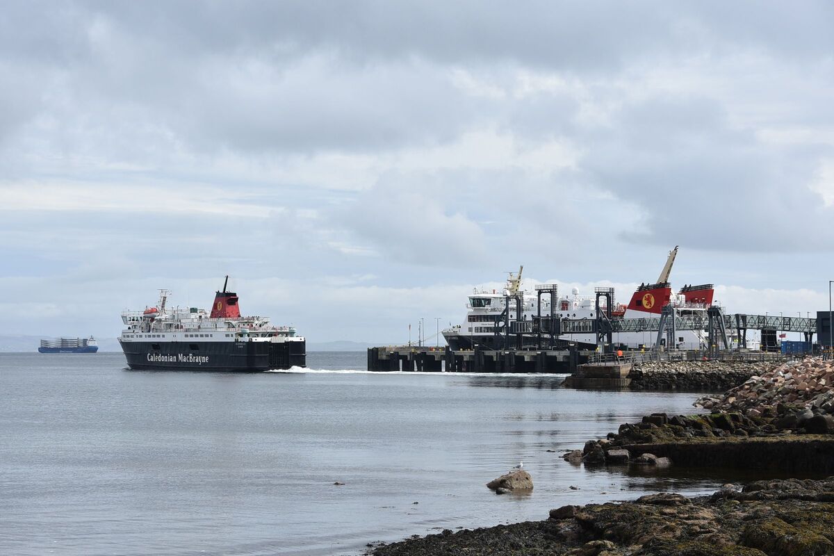 MV Caledonian Isles departs from Brodick ferry terminal while broken down MV Glen Sannox remains berthed at the east pier.