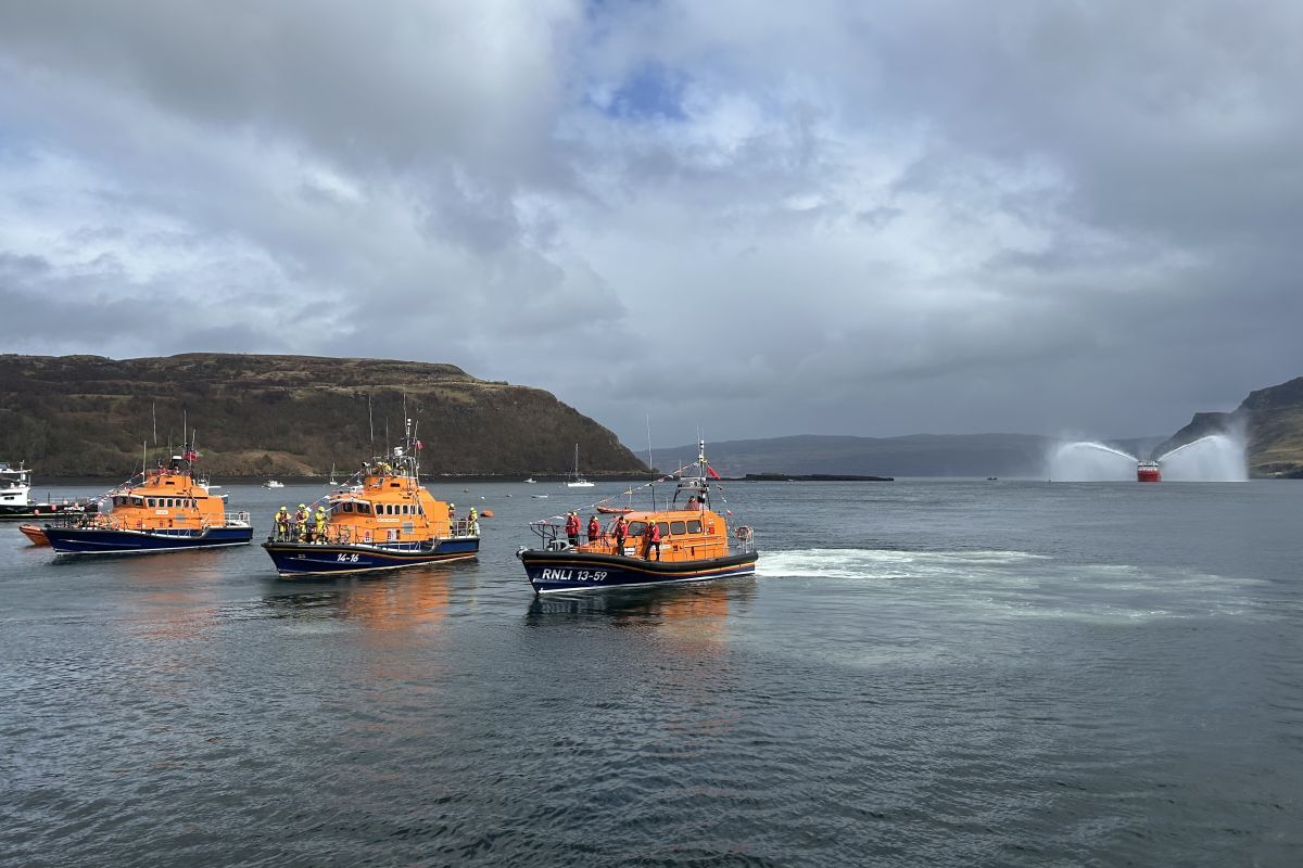 Portree's new lifeboat arrives escorted by other vessels and with a traditional water canon saltute. Photograph: Robert  MacInnes/RNLI