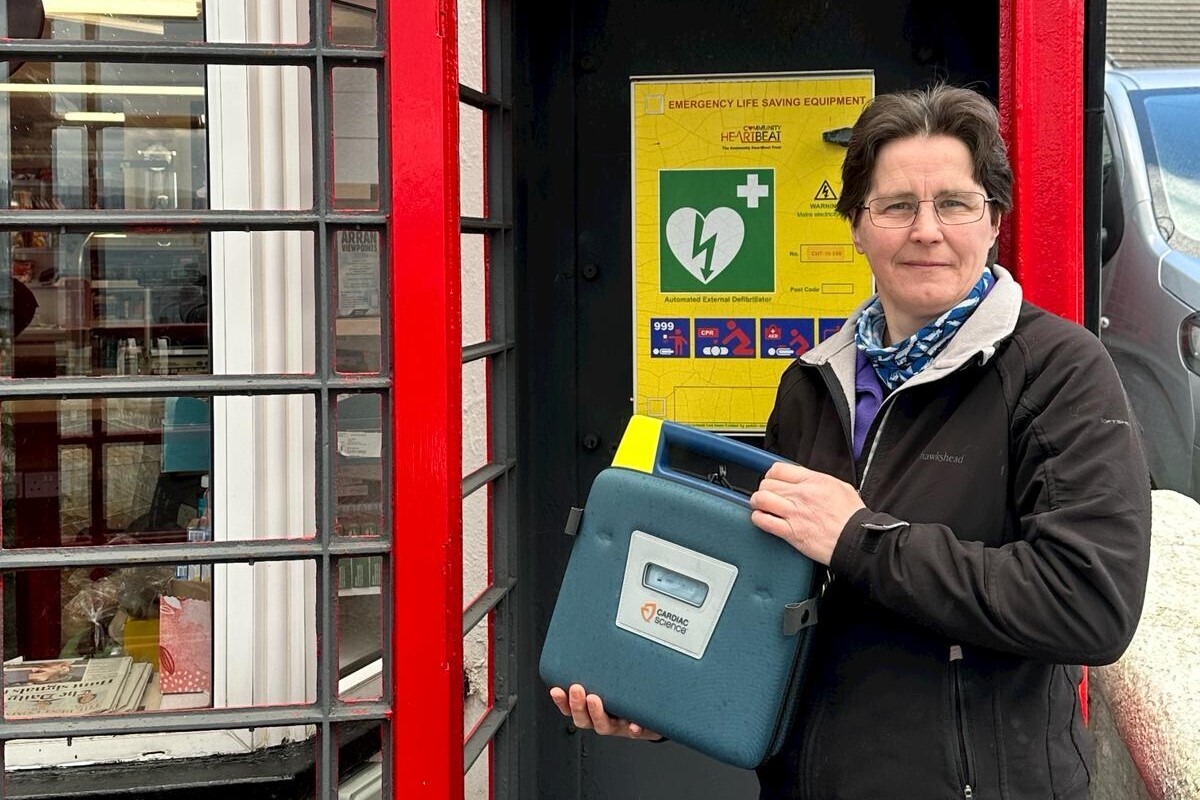 Fiona Laing with the Arran Defib Project&rsquo;s public access defibrillator in Pirnmill. Photograph: Supplied.
