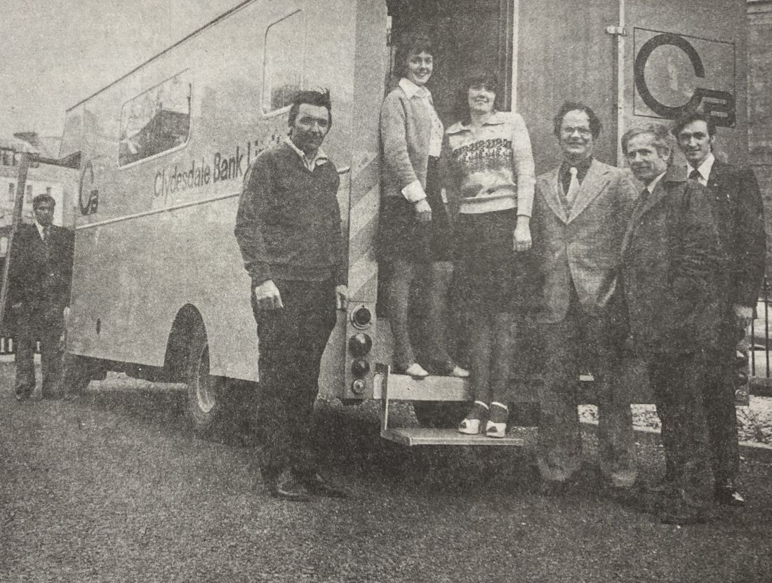 1976: Bank staff and customers at Portree inspecting the newly arrived mobile bank. Pictured from left are:&nbsp;Mr Donald MacKinnon, Mr George Lamond,&nbsp;Miss Mary MacLeod, Miss Jessie Martin, Mr Alasdair Stewart,&nbsp;Mr William Lightbody, Mr Iain Campbell.