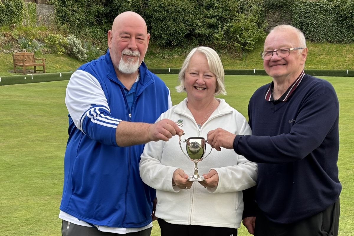 Oban Bowling Club President Anne MacDougall presented David McLaren, left, and Peter MacKinnon with the Caledonian Pairs trophy.