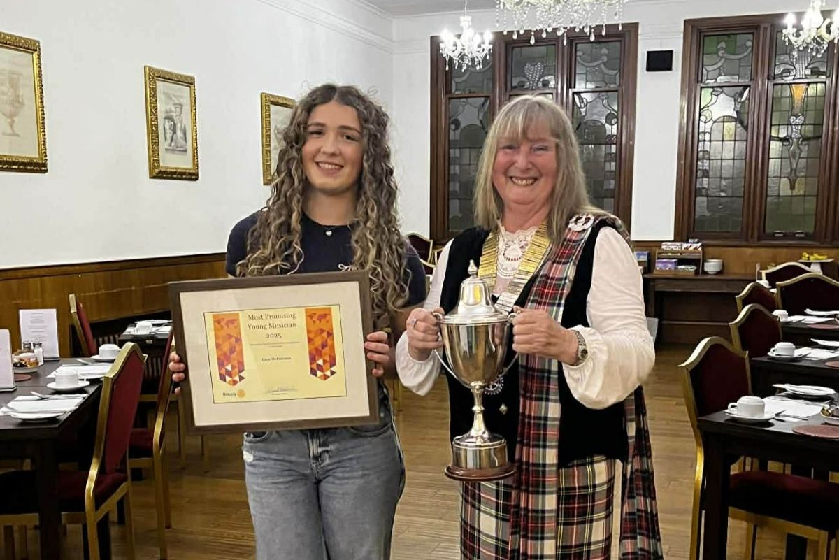 Most Promising Young Musician of the Year Cara McFadzean receiving her award from Rotary president Gail Edwards.