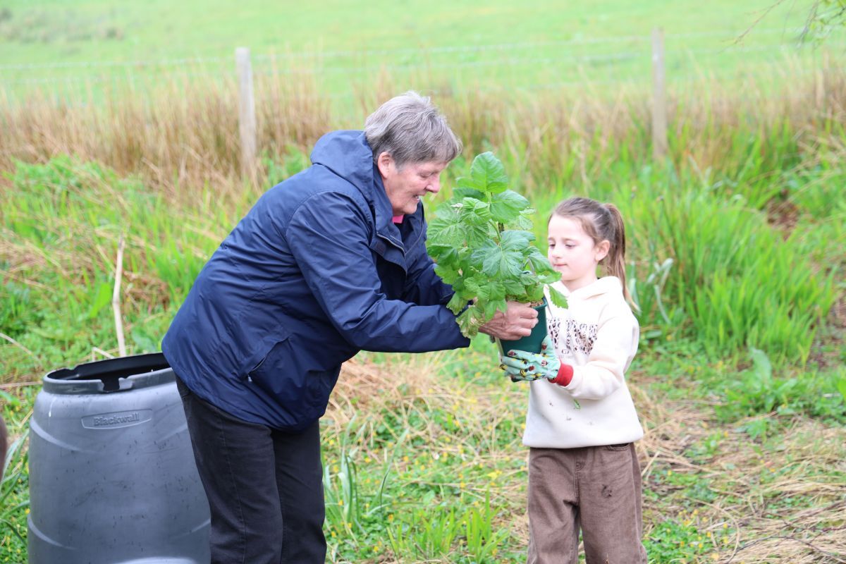 Margaret Sinclair and Rhyia Blair plant a fruit bush. Photograph: Kenny Craig.