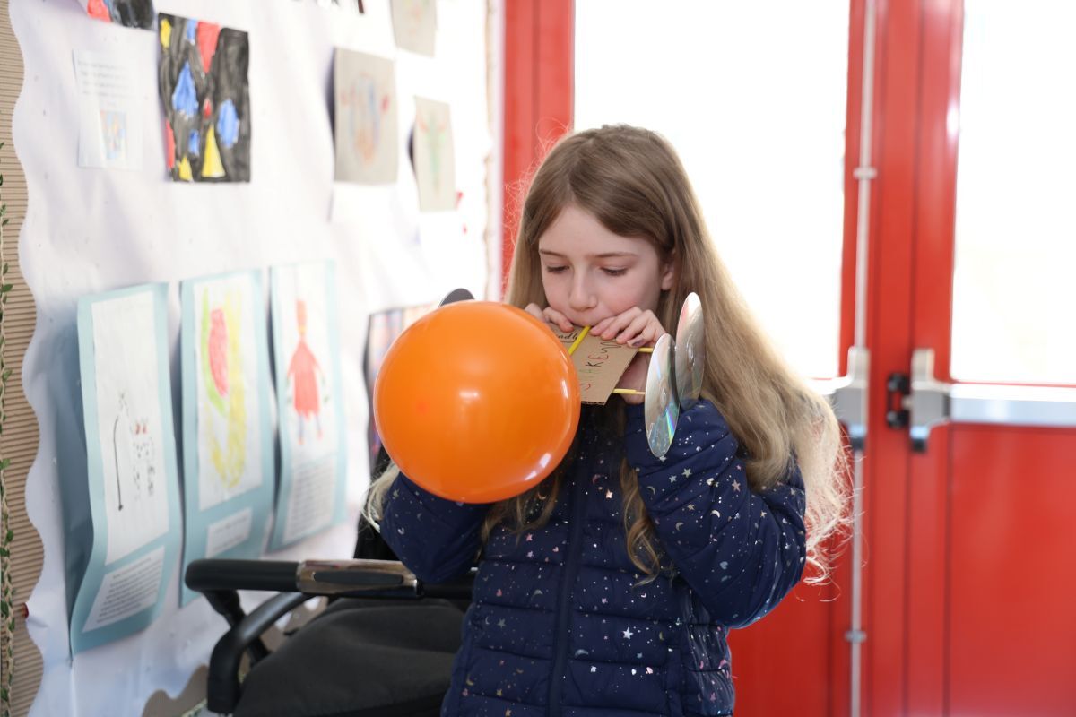 Camille Loganbill tests a balloon-powered car. Photograph: Kenny Craig.