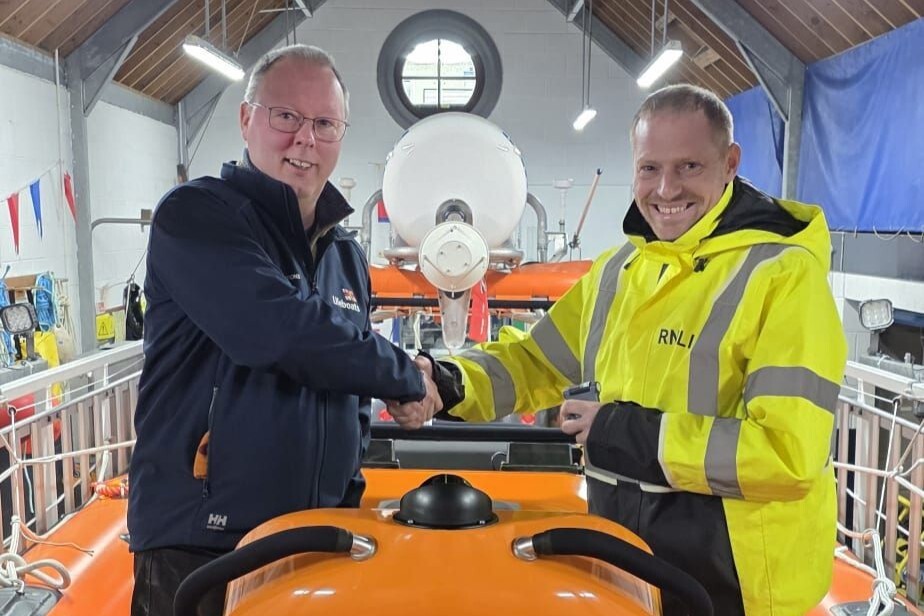 Arran RNLI operations manager, Graeme Brown, presented Mark Cook with his pager on completion of his crew training last month. Photograph: RNLI.