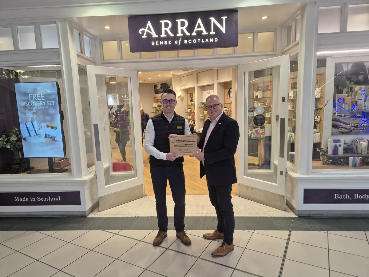 Arran Sense of Scotland’s Kevin Meechan and Keep Scotland Beautiful’s Barry Fisher with the silver National Award for Environmental Excellence. Photograph: Keep Scotland Beautiful.