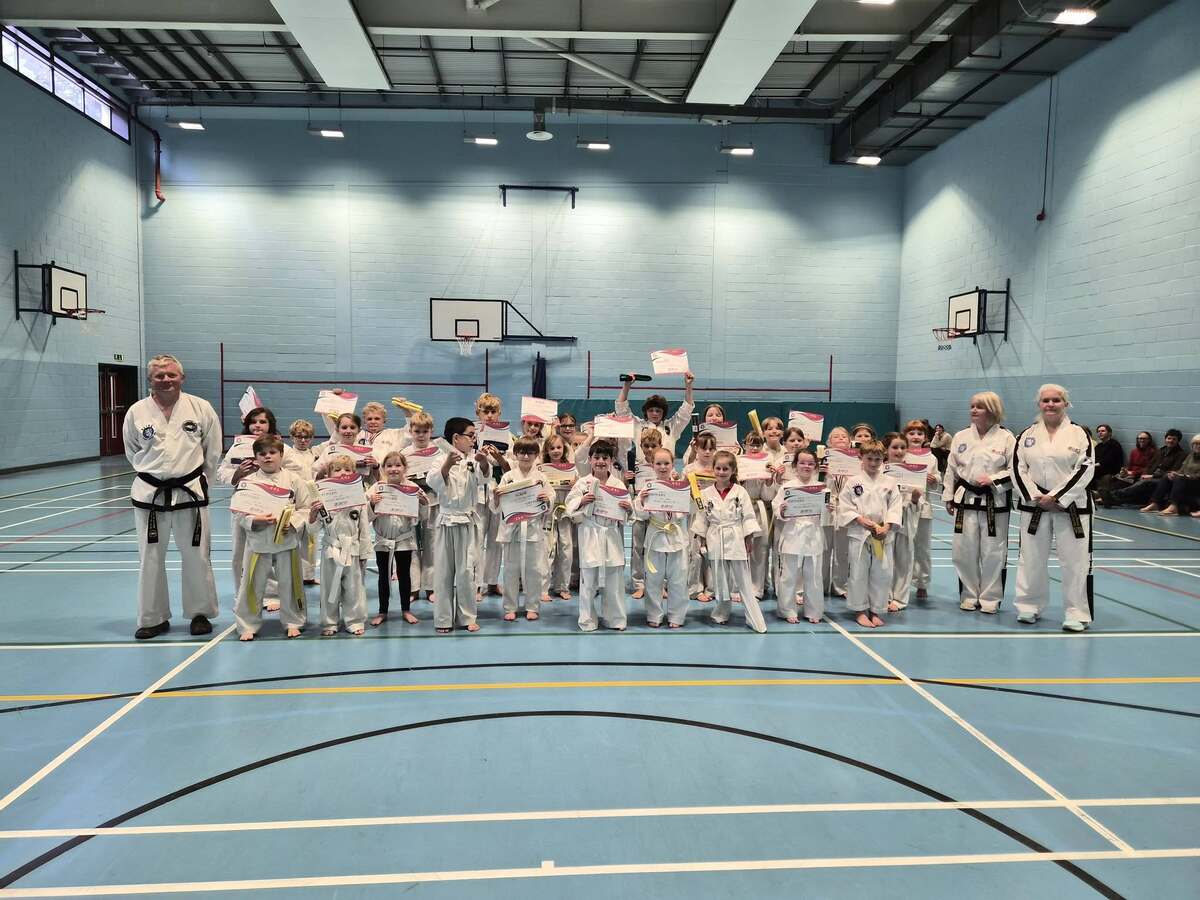 Master Catherine Divine, Debbie McNally and Michael Banasik with the young Taekwondo students who received their gradings. Photograph: Supplied. 