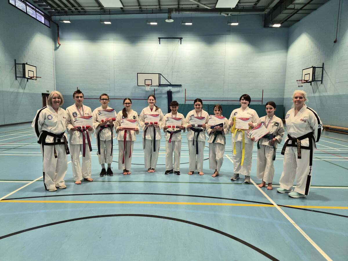 Taekwondo teacher, Debbie McNally and Master Catherine Divine with the junior pupils who received their gradings. Photograph: Supplied.