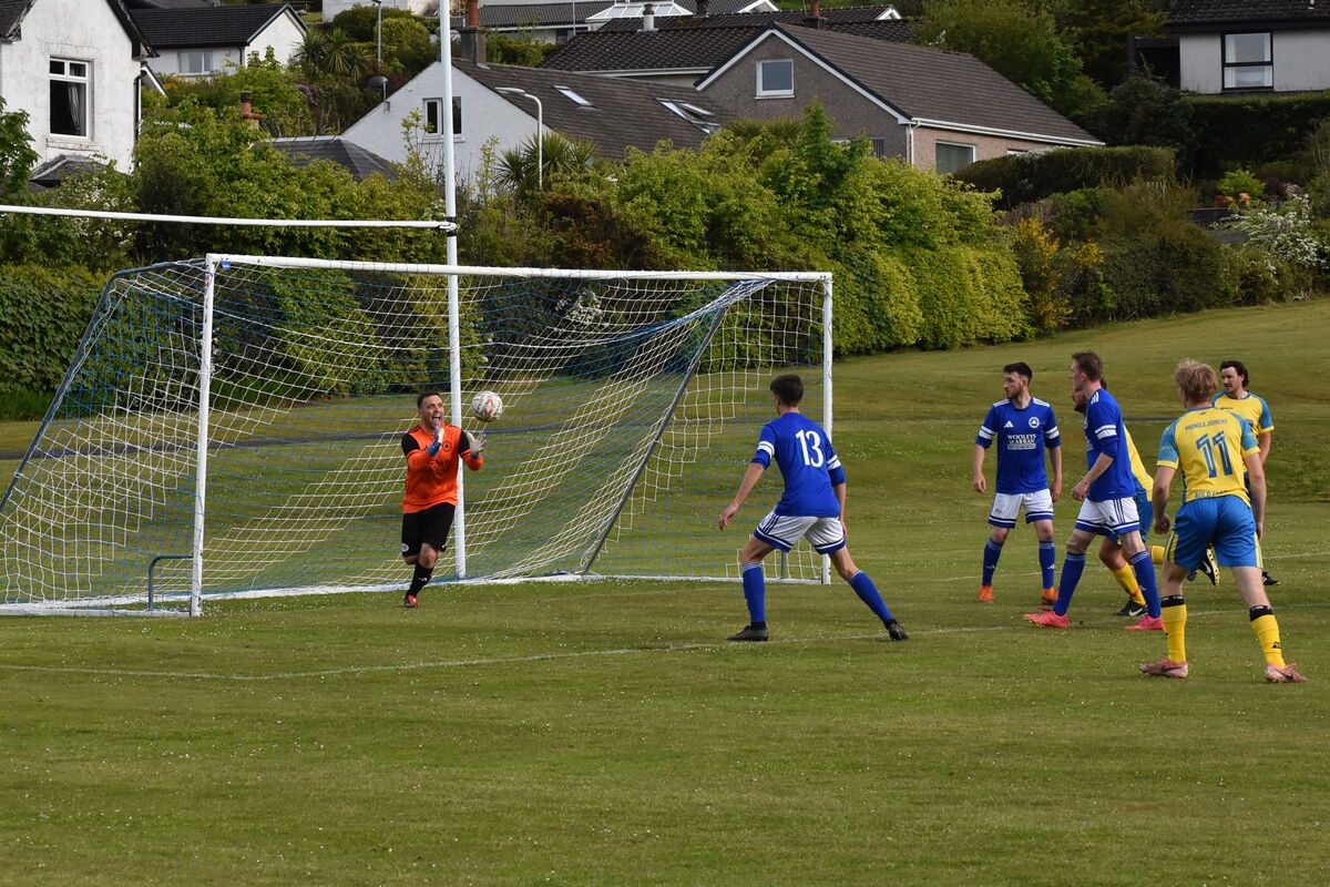 Brodick keeper Christopher MacNeil taunts Southend players as he intercepts an attempt at goal.