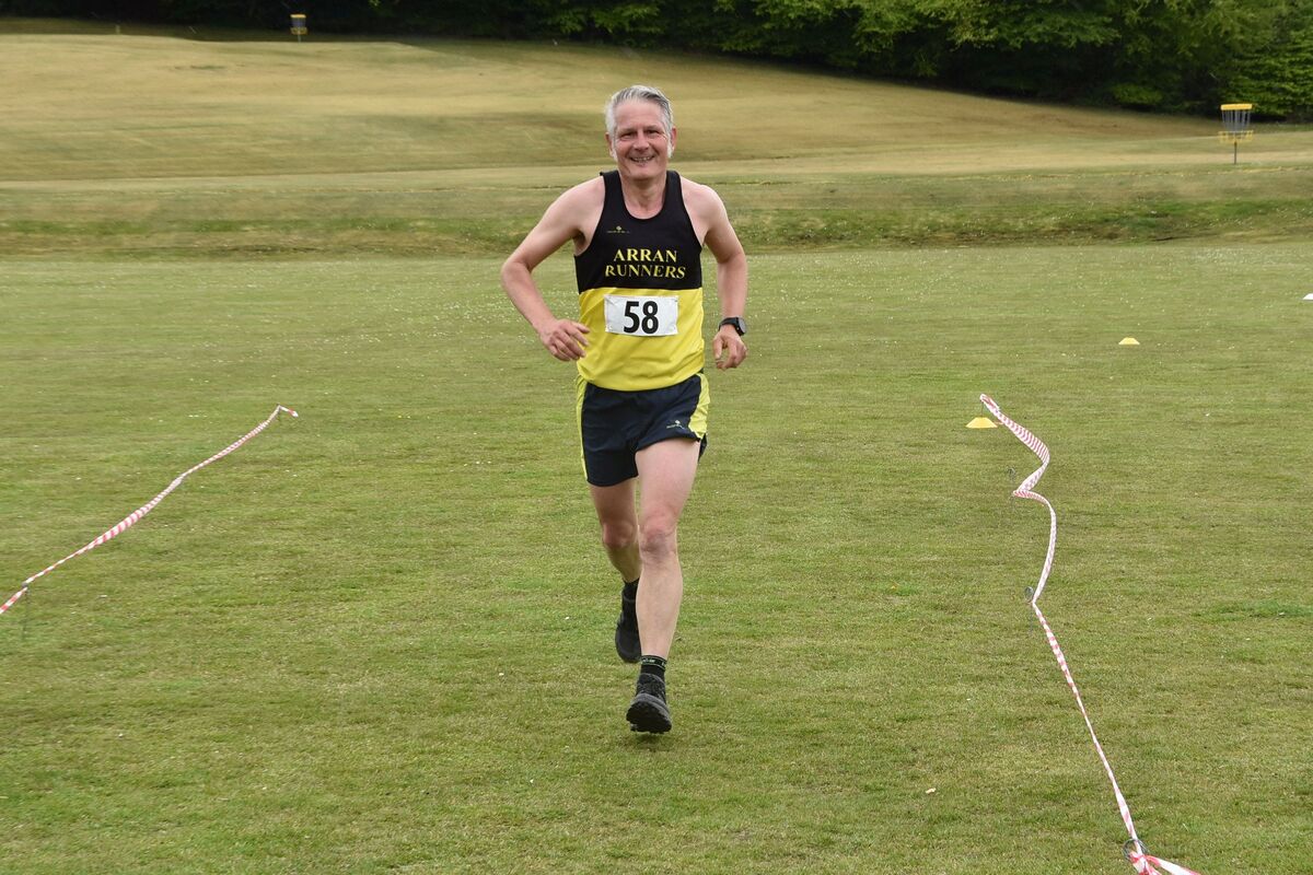 Mark Bentley, first male local over the finish line, ends his race with a smile on his face.
