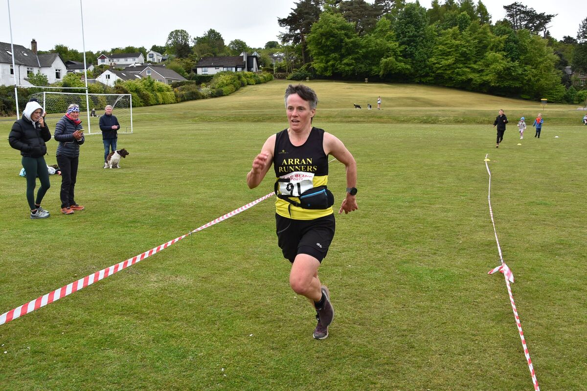 Lynda Fenton gives one final push to finish as the first local female over the line.