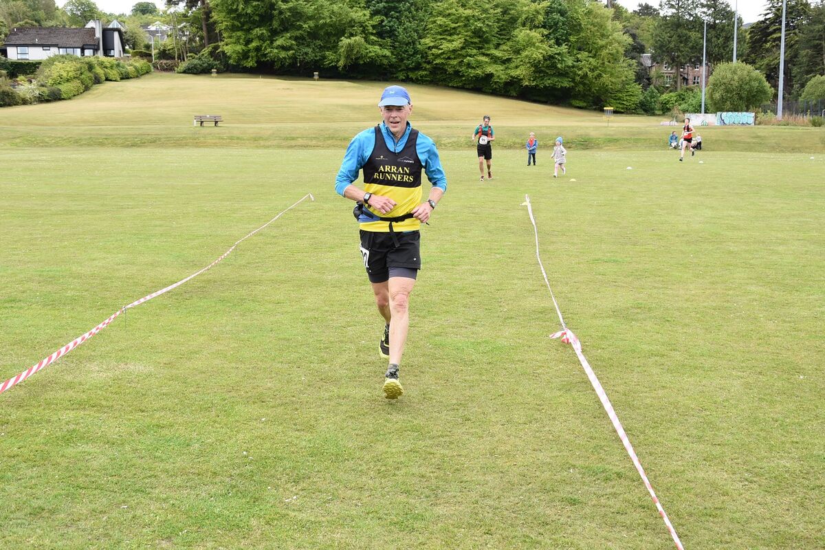 Arran Runner Stephen Jones, competing in the over 70 category, crosses the finish line.