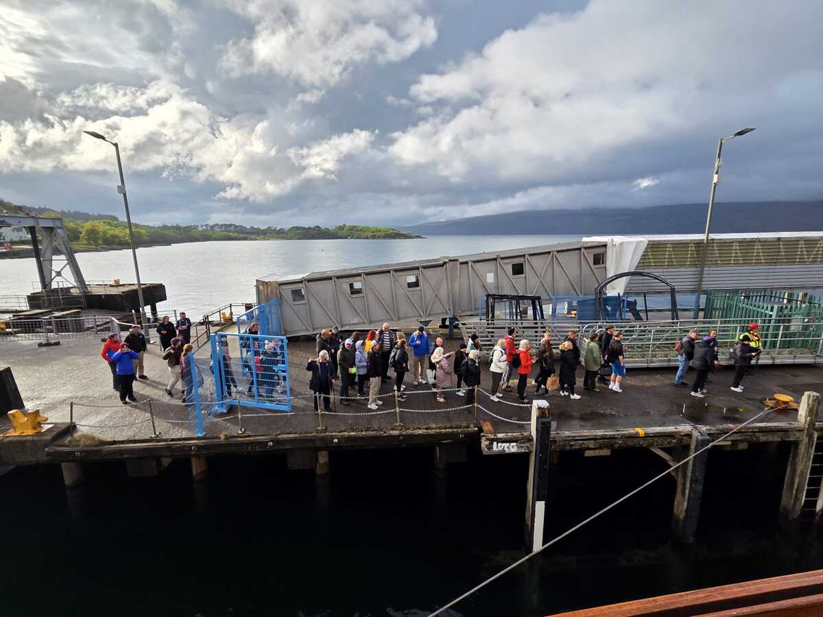 Passengers gathering on Craignure Pier to board Waverley for the return sailing to Oban.