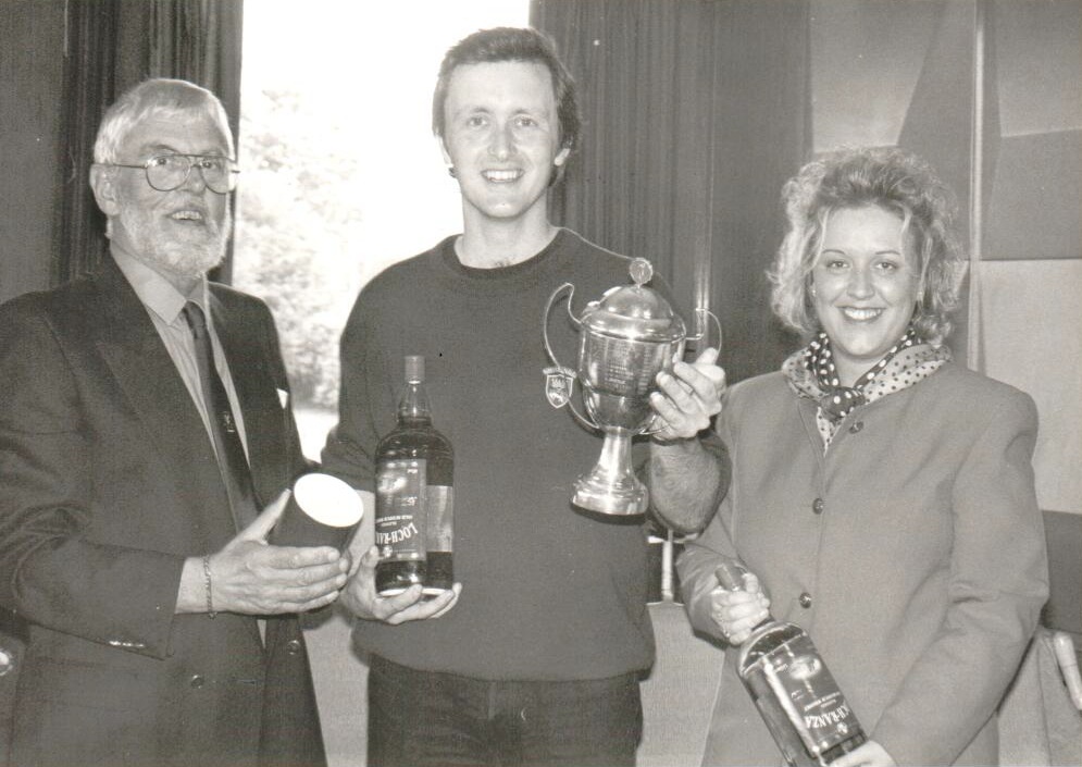 Greg McCrae is the winner of the Arran Open played at Brodick Golf Club. With him is club captain Douglas Jenkins and Gillian McCreadie of Arran Distillery.