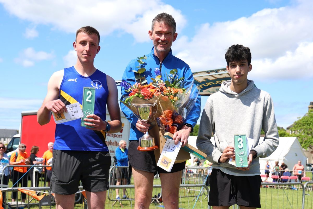 Men’s 10k winner Stuart McGeachy, centre, is joined by runner-up Neil Littleson, left, and third-placed Krishnan Davidson, right. Photograph: Kenny Craig.