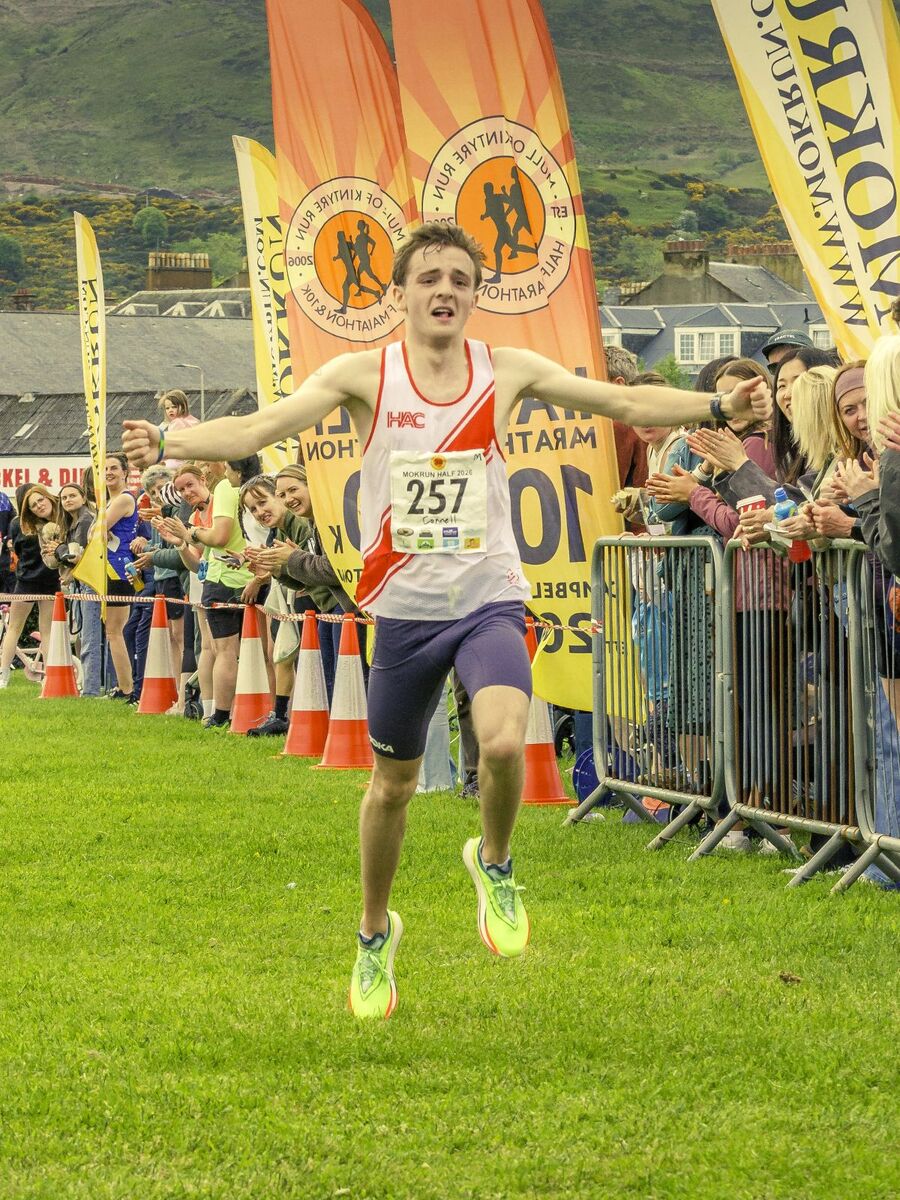 Connell Metcalf crosses the line to win the men’s half marathon. Photograph: John Coffield.