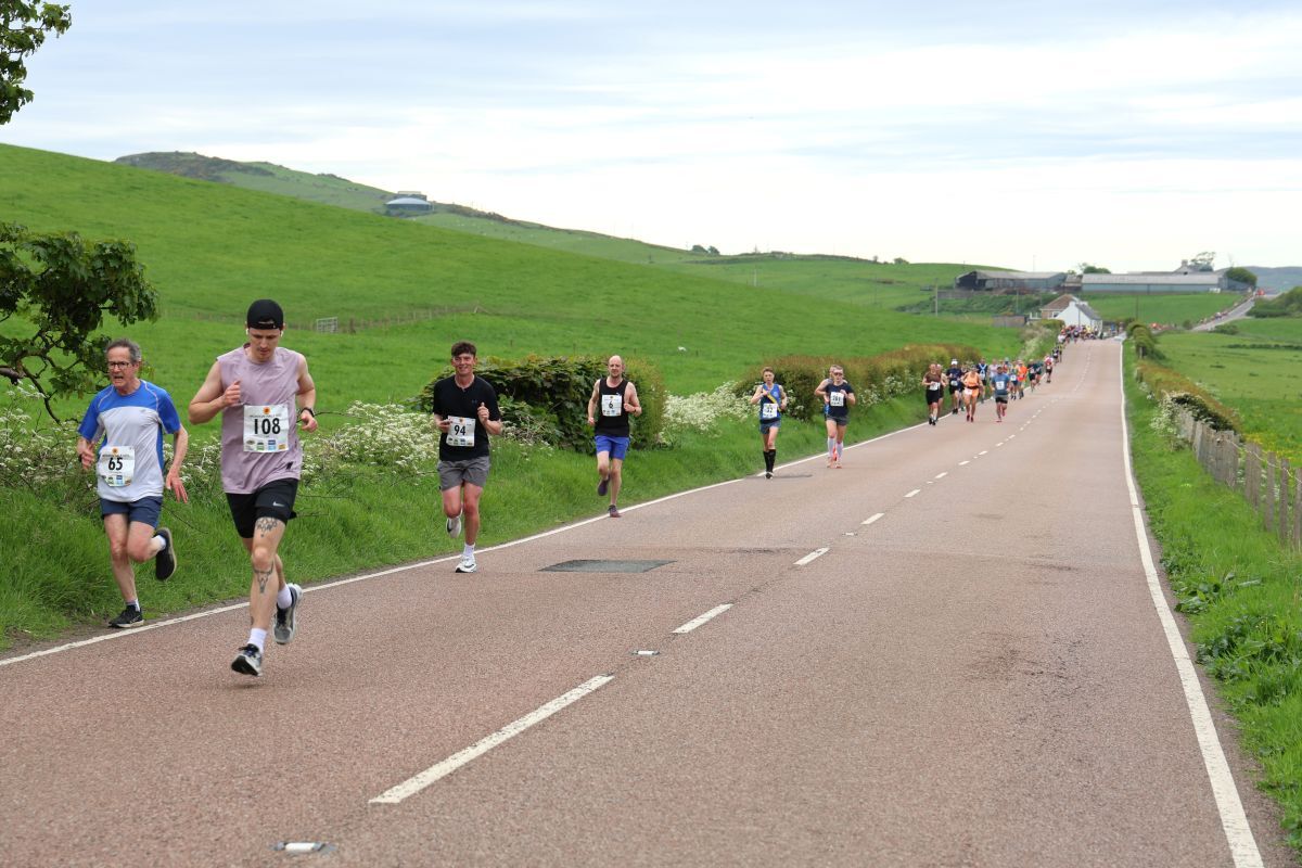 Half marathon runners make their way out towards Westport. Photograph: Kenny Craig.