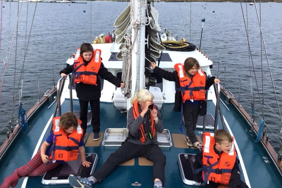 Youngsters aboard Silurian try out marine wildlife spotting techniques. Photograph: Gigha Primary School.