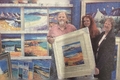2006: . John Lowrie Morrison hands over one of his works of art to Heather Bellshaw, Tarbert Youth Group leader and Janey Milne, Tarbert Village Hall fundraiser. 