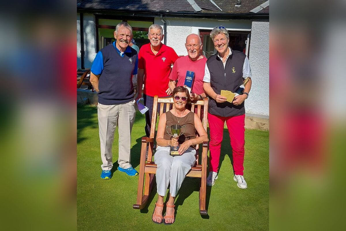 Seniors Open champion Lynda Blair, in the champions chair with Douglas Auld, runner up day one, Whiting Bay captain Gus MacLeod, David Brookens, winner day one and runner up on day two, and Charlotte Taylor, third place on day two. Photograph: WBGC.